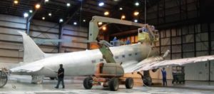 Military aircraft is prepared for repainting.